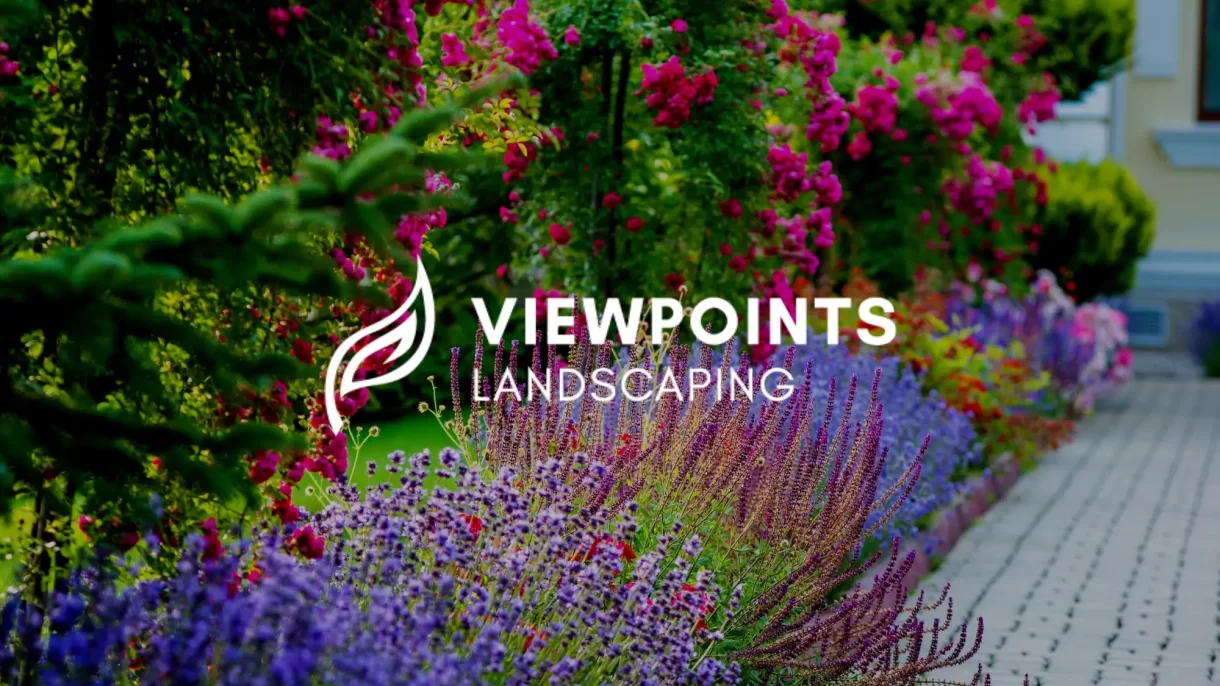 An image of landscaped flowers and lush greenery on a street curb with the Viewpoints Landscaping logo superimposed on the front.