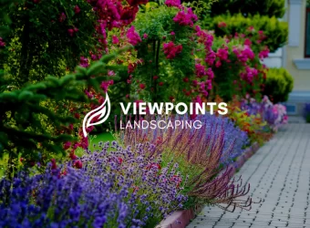 An image of landscaped flowers and lush greenery on a street curb with the Viewpoints Landscaping logo superimposed on the front.
