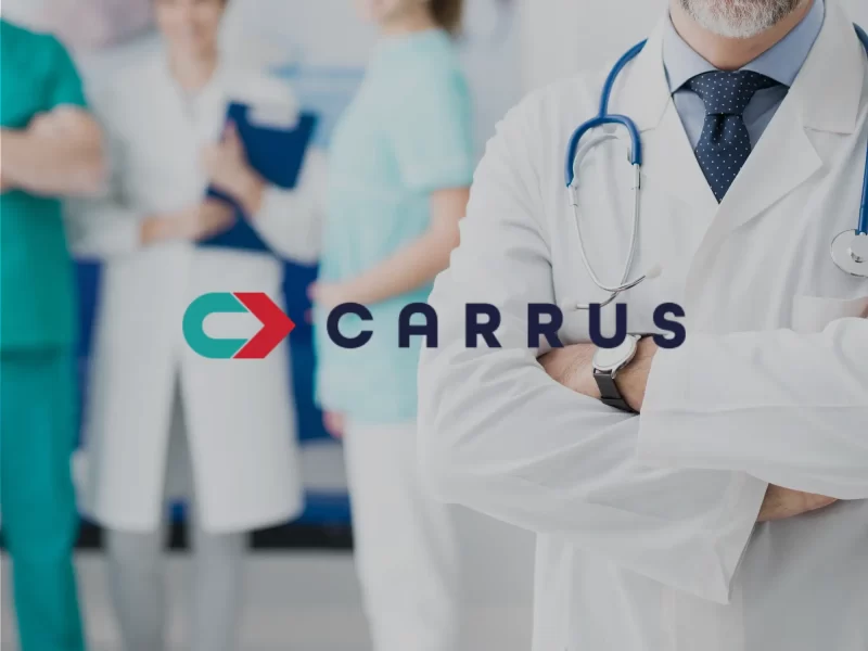An image of medical providers in the background with their arms crossed and speaking, with the Carrus logo superimposed on the front of the image.