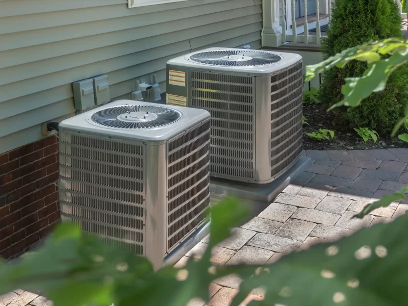 An image of AC units behind a house.